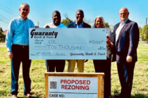 customer holding large check